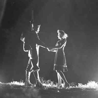 Soldier and a girl posing for a night photo