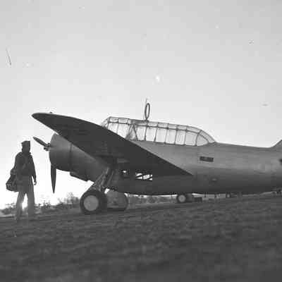Airman standing next to aircraft