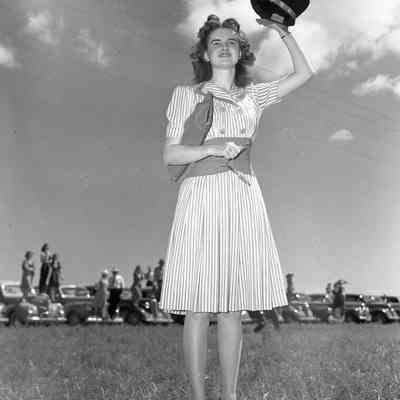 Girl waving her hat