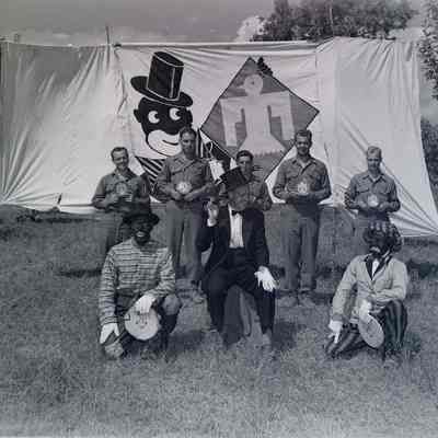 Blackface minstrels in front of a 45th banner