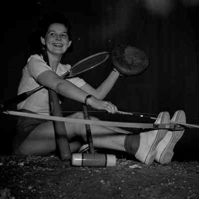 Girl posed with multiple items of sports gear