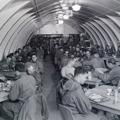 Soldiers dining in a Quonset-hut mess hall