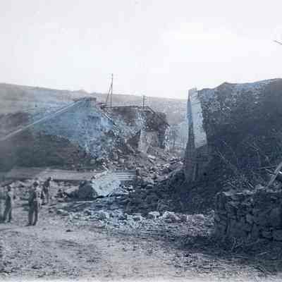 Soldiers standing next to rubble