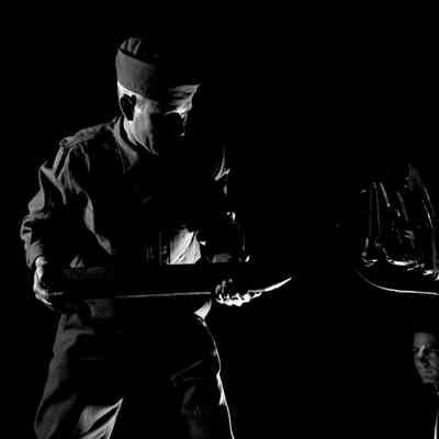 Soldier loading artillery shell into gun