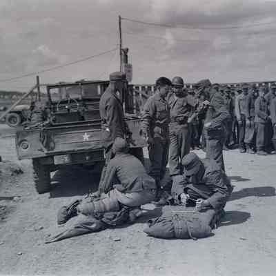 Prisoners packing before being loaded into trucks