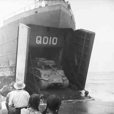 Tank exiting a landing craft onto beach
