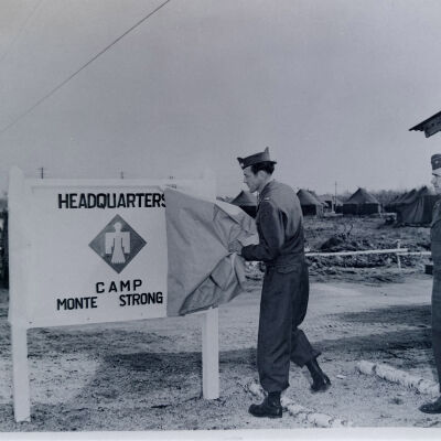 General Muldrow and another soldier unveiling sign for HQ at Camp Monte Strong