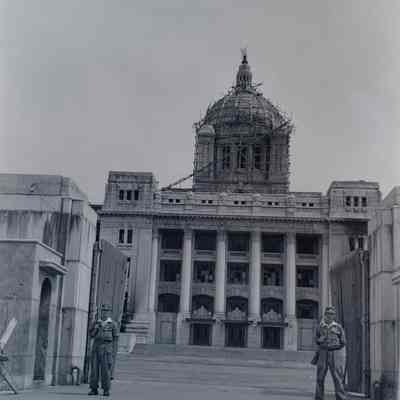 Damaged government building guarded by soldiers