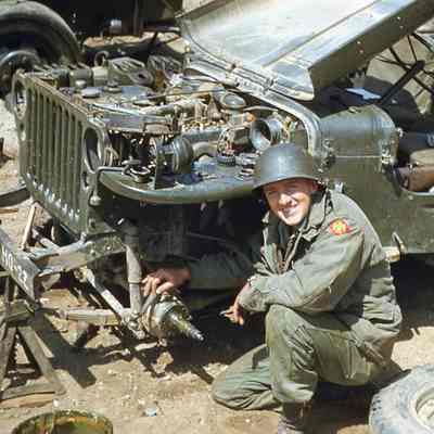 Soldier working on jeep