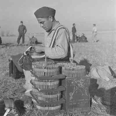 Soldier fitting ammunition into machine gun bandoliers