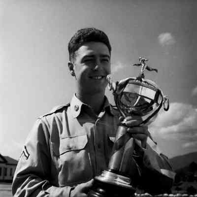 Soldier holding a baseball trophy