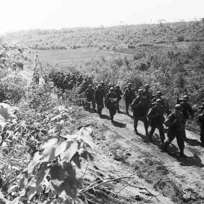 Soldiers on a road march in a rural area