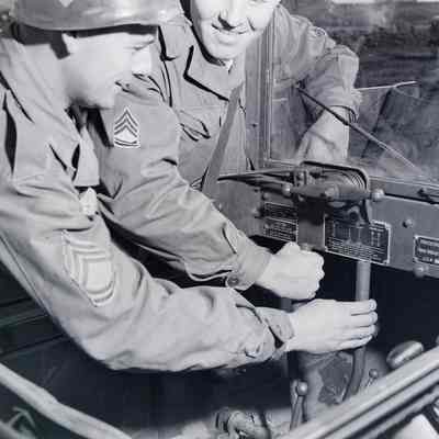 Soldiers learning the controls of an amphibious tracked vehicle