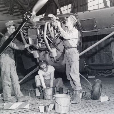 Mechanics working on a small aircraft