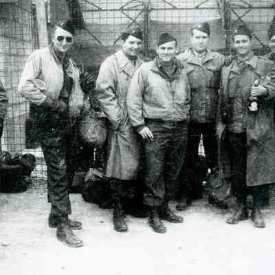Soldiers posing with captured liquor bottles