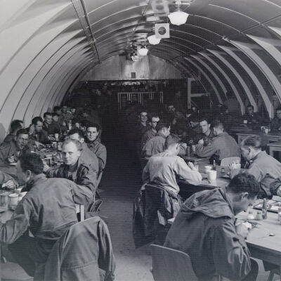 Soldiers dining in a Quonset-hut mess hall