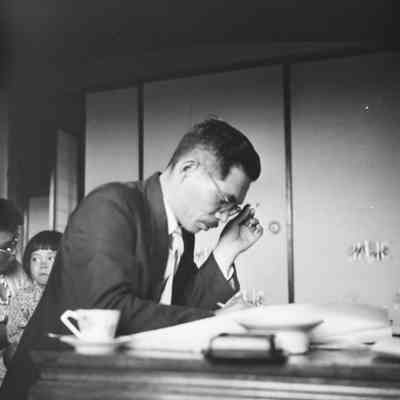 Japanese man writing at desk
