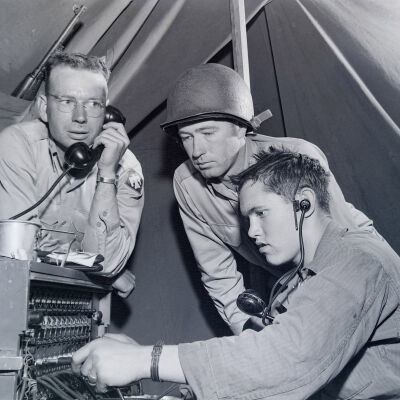 Soldiers gathered around a field phone switchboard