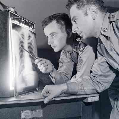 Two soldiers examining a chest X-Ray