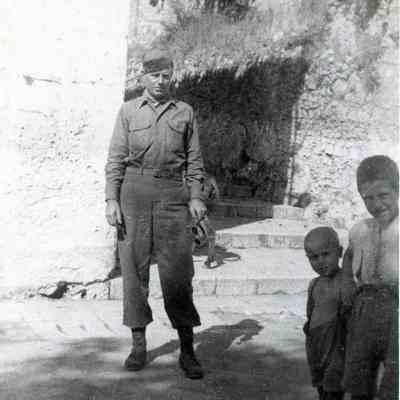 Soldier poses for a photo with Italian Kids