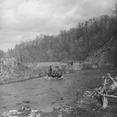 Jeeps fording a stream