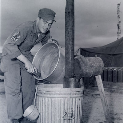 Soldier cleaning a pot