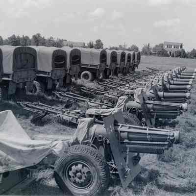 Trucks lined up with artillery pieces