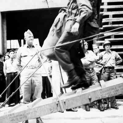 General Styron watching soldiers coming down gangway from ship