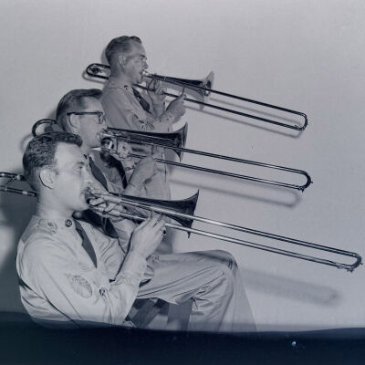 Three soldiers playing trombones