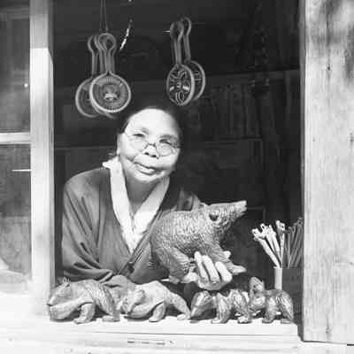 Japanese woman selling wood carvings