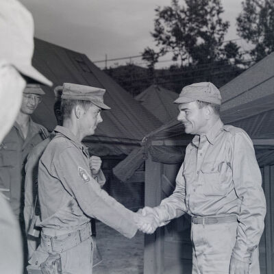 Officer greeting soldiers