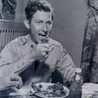 Soldier enjoying his meal of steak and French fries