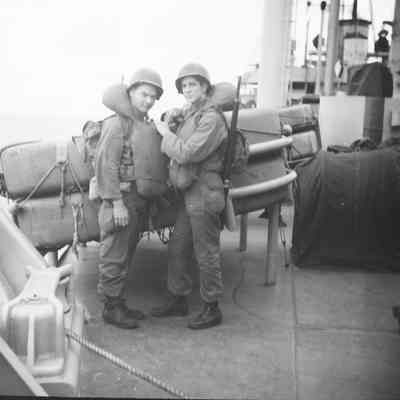 Soldiers checking each other's life vests