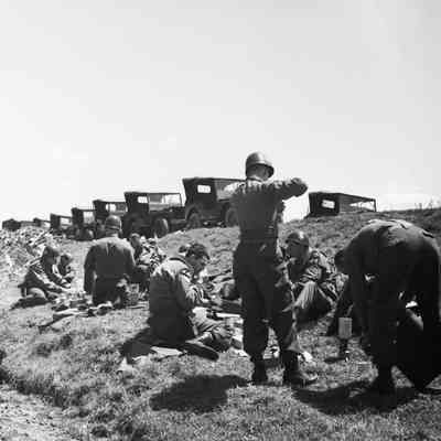 Soldiers eating along the roadside