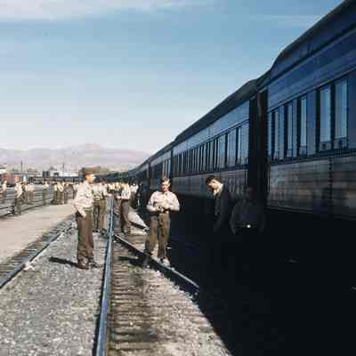 Soldiers standing outside next to a troop train