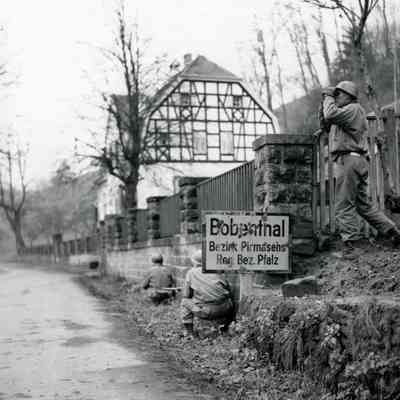 Soldier searches outskirts of a town