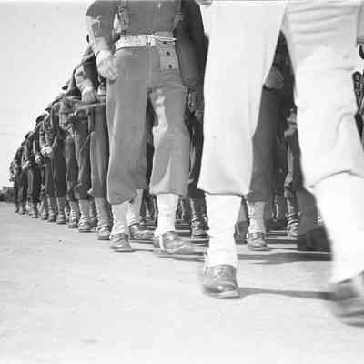 Soldiers marching in city street