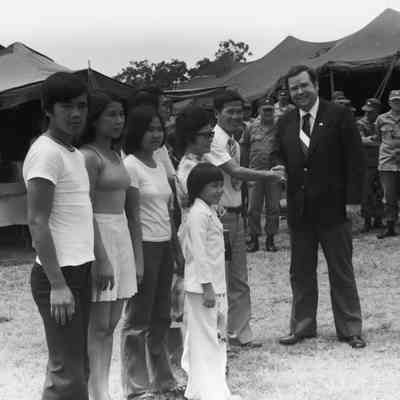 Govenor David Boren meeting a refugee family from Vietnam