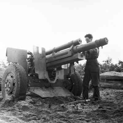 Soldier working on artillery piece
