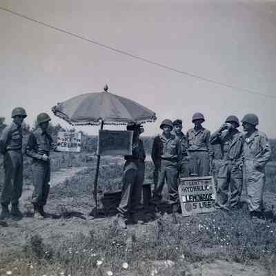 Soldiers gathered around a lemonade stand
