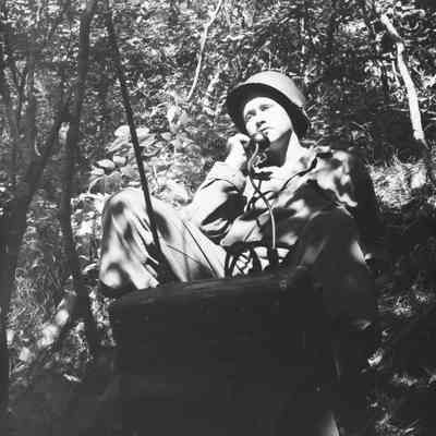 Soldier using a field radio in the woods