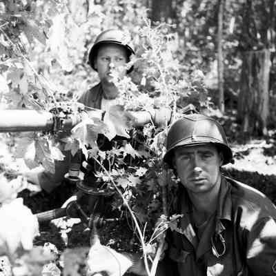 Soldiers in a commouflaged recoiless rifle position