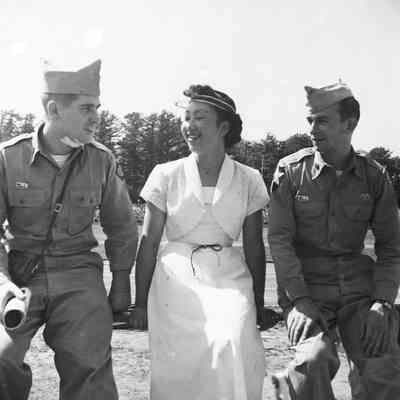 Soldiers sitting with a Japanese woman during a track event