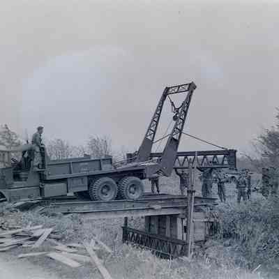 Soldiers assembling Bailey Bridge components using an A Frame truck