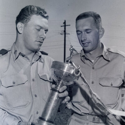 Soldiers with a baseball trophy