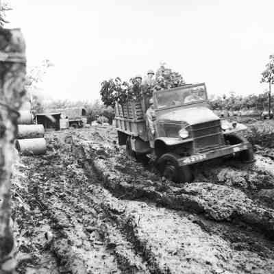 Truck carrying soldiers through deep mud