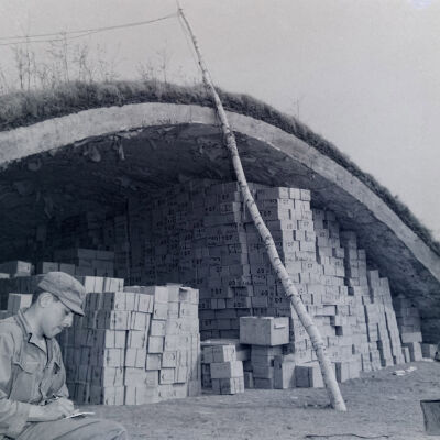 Soldier sitting in front of ration dump