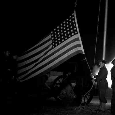 Soldiers taking down American flag