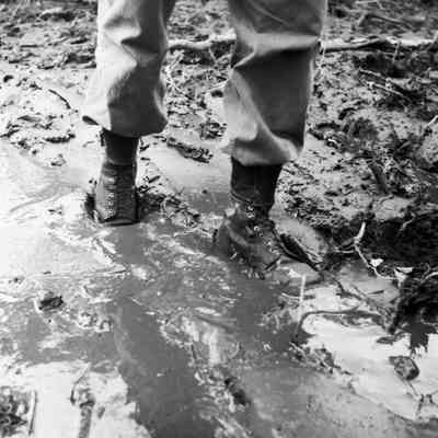 Soldier walking through deep mud