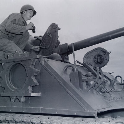 Soldier on tank with binoculars